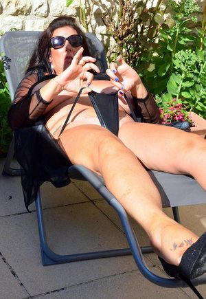 1 dark haired female tortures another during lezdom play in concrete cellar